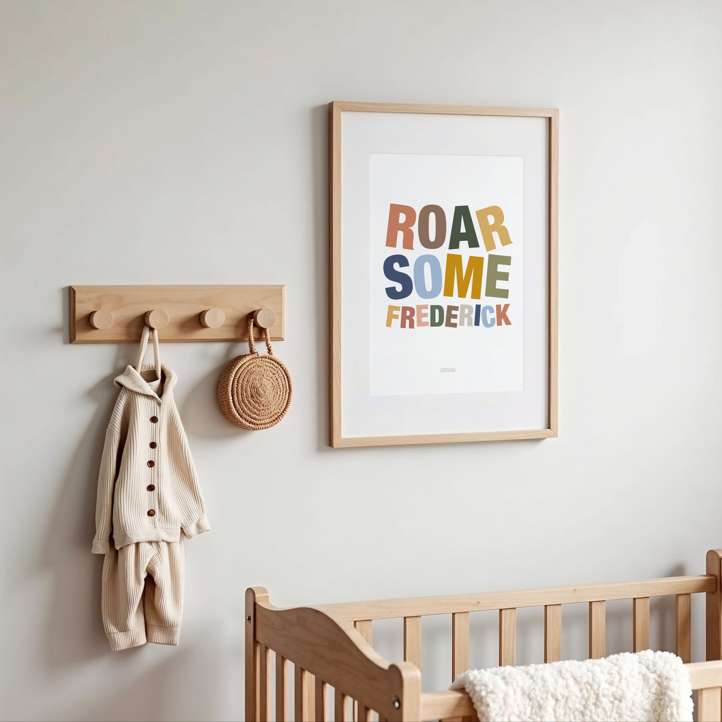 Framed artwork with 'ROAR some FREDERICK' text in a nursery setting.